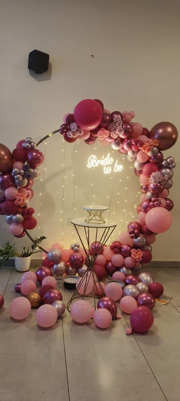 Bride to be celebration setup with rose-pink balloon arch