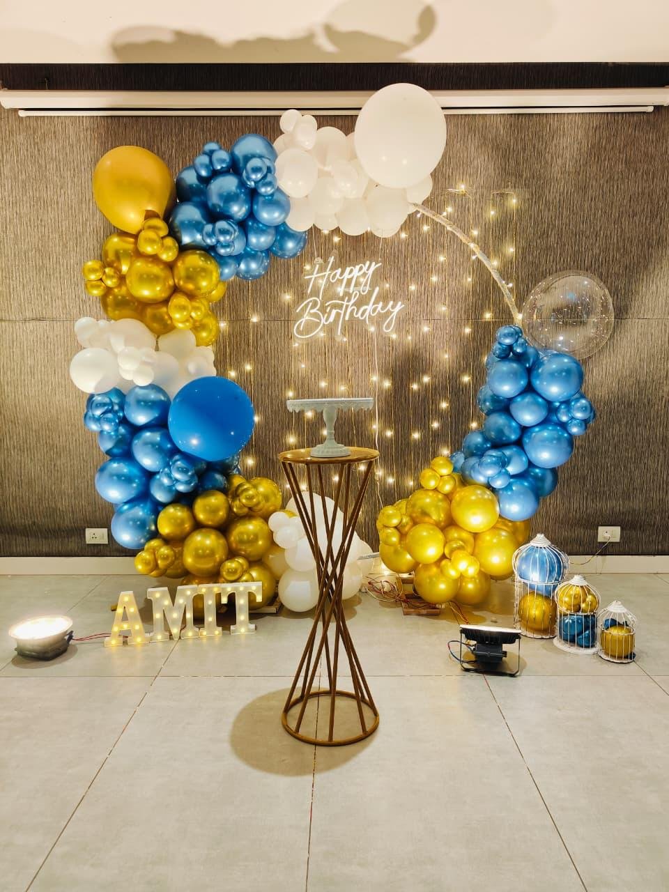 Blue and gold birthday setup with name lights